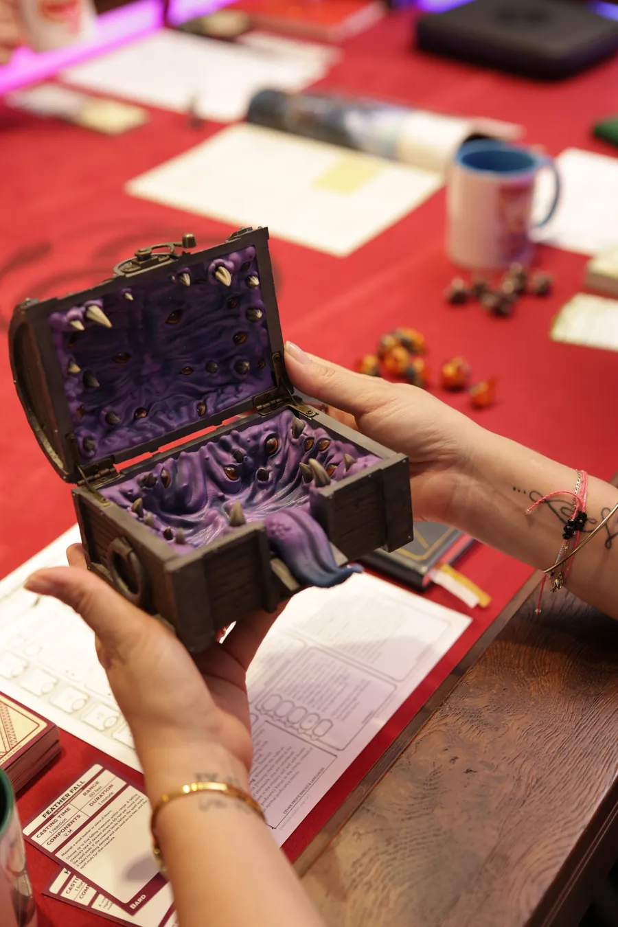 Two players passing the open Mimic Dice Box across the table