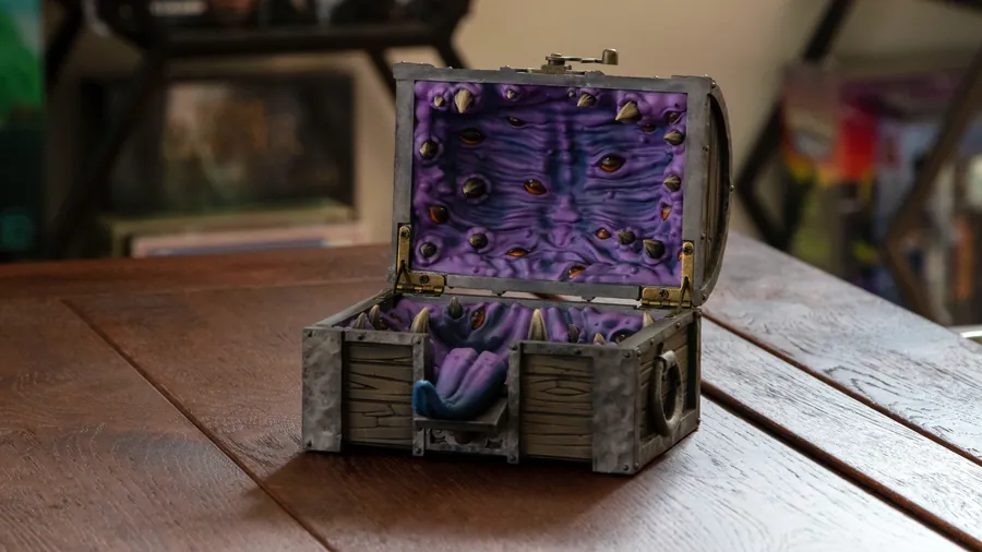 The open Mimic Dice Box on a table with its tongue out