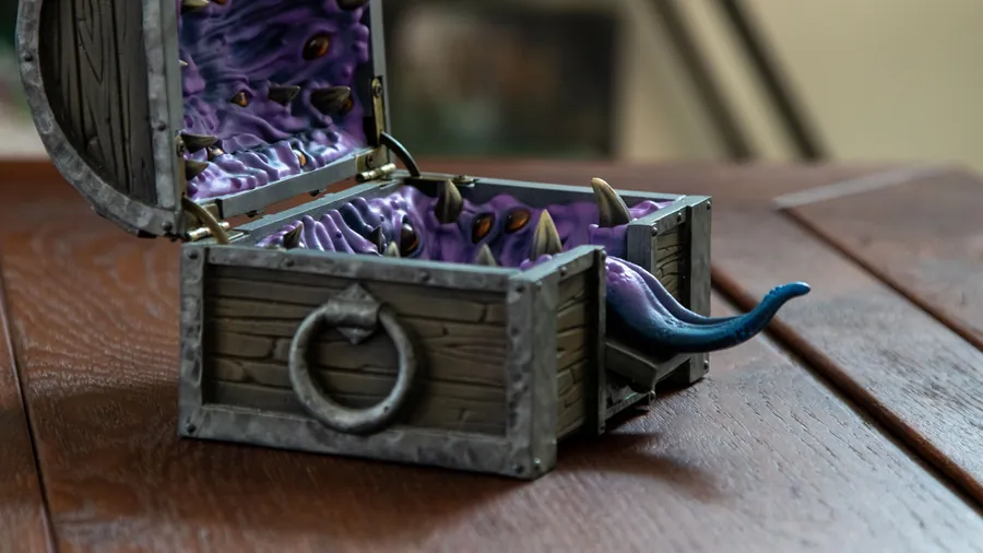 The Mimic Dice Box with its blue tongue draped over the front edge