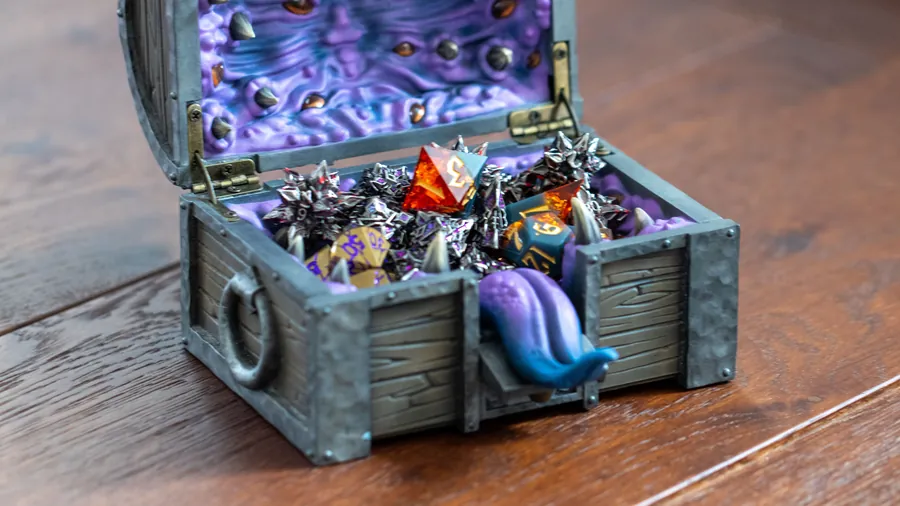 The open Mimic Dice Box on a wooden table, tongue out